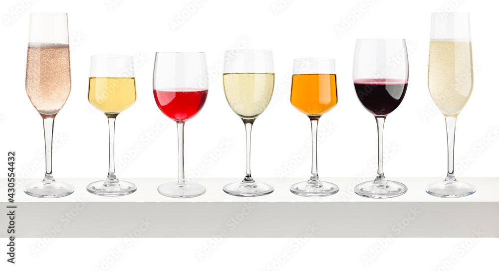 Glasses with different wine on white shelf. Glasses with different wine on white shelf.