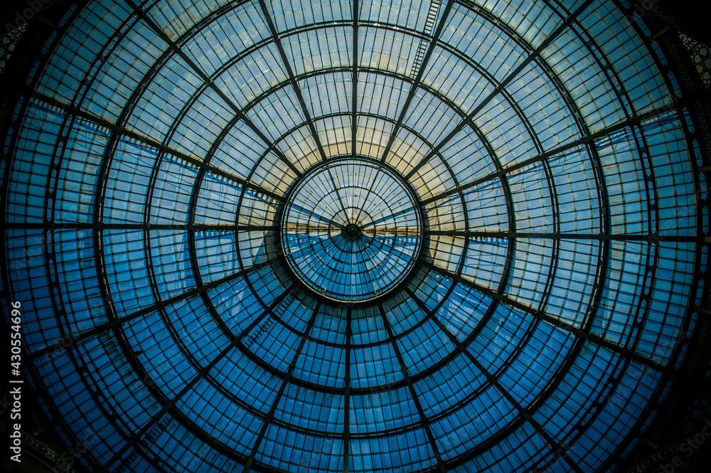 Abstract circular pattern of the glass dome of the Galleria Vittorio Emanuele II in Milan, Lombardy, Italy.