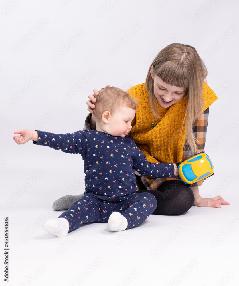 Older sister plays with a charming baby Older sister plays with a charming baby