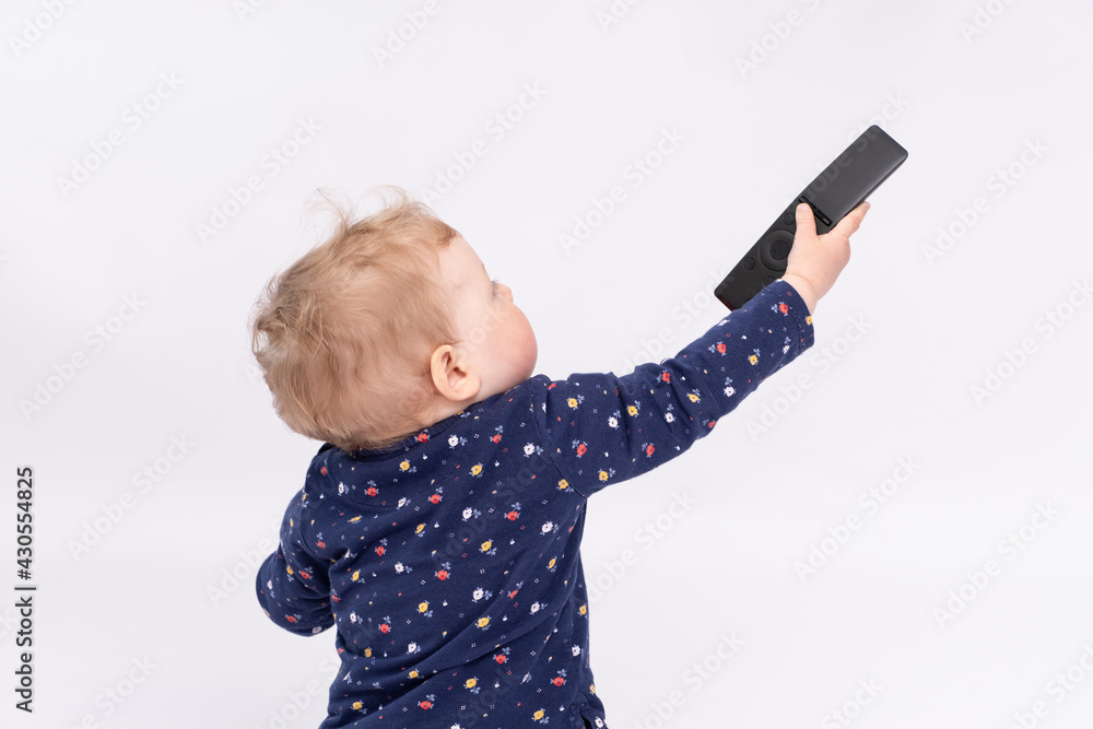 Pretty baby girl plays with a remote controller Pretty baby girl plays with a remote controller