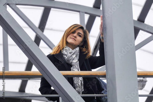 young woman among the urban structures of the covered overpass