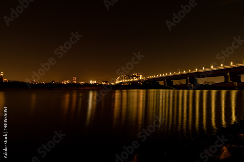 Night wide city view of Nijmegen. Bridge at night, reflection in the water © MA