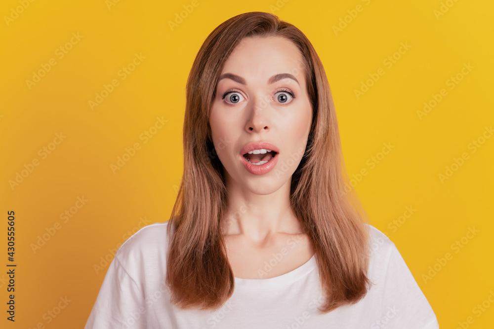 Close-up portrait of surprised beautiful girl open mouth on yellow background Close-up portrait of surprised beautiful girl open mouth on yellow background