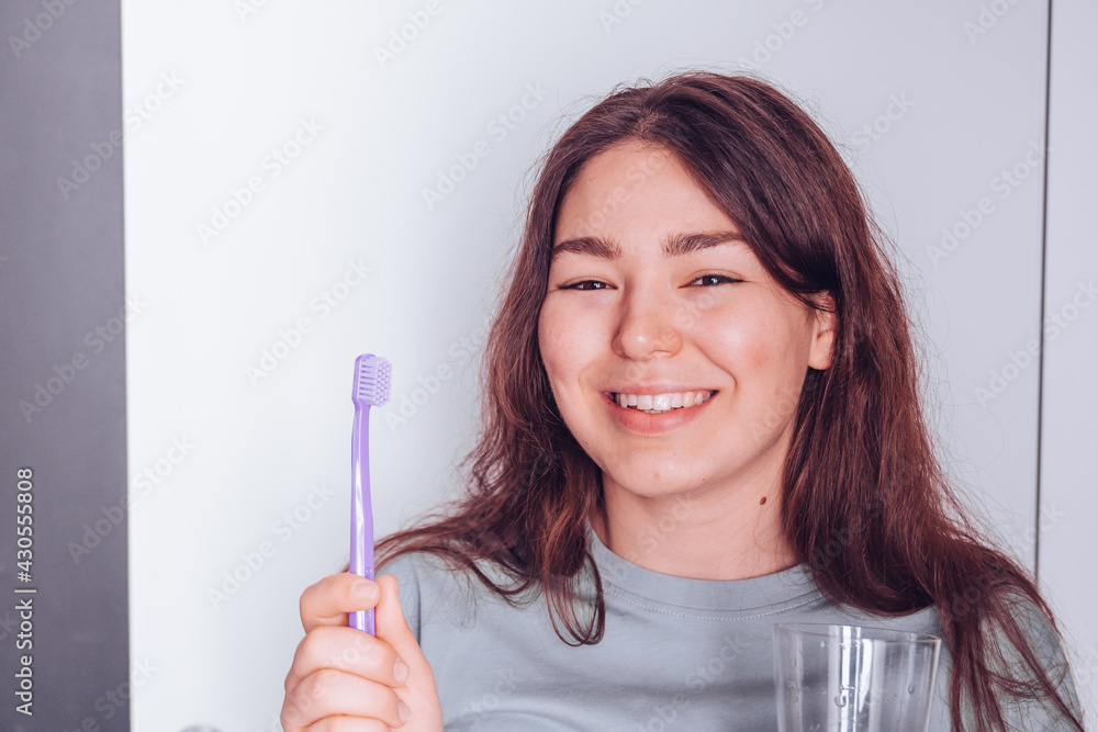 young attractive woman brushes her white teeth young attractive woman brushes her white teeth