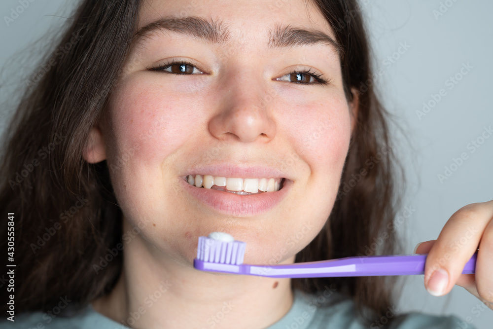 Close-up portrait of young sweet girl brushing teeth at home Close-up portrait of young sweet girl brushing teeth at home