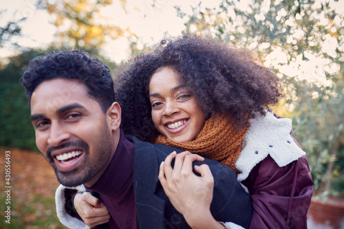 Portrait Of Loving Young Couple Hugging Outdoors In Fall Or Winter Countryside