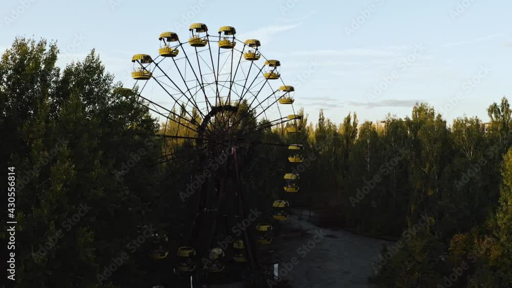 Aerial drone view of Pripyat Ferris wheel. Pripyat near the Chernobyl nuclear power Exclusion zone. Afternoon Sunset in Autumn - Beautiful Lighting Aerial drone view of Pripyat Ferris wheel. Pripyat near the Chernobyl nuclear power Exclusion zone. Afternoon Sunset in Autumn - Beautiful Lighting