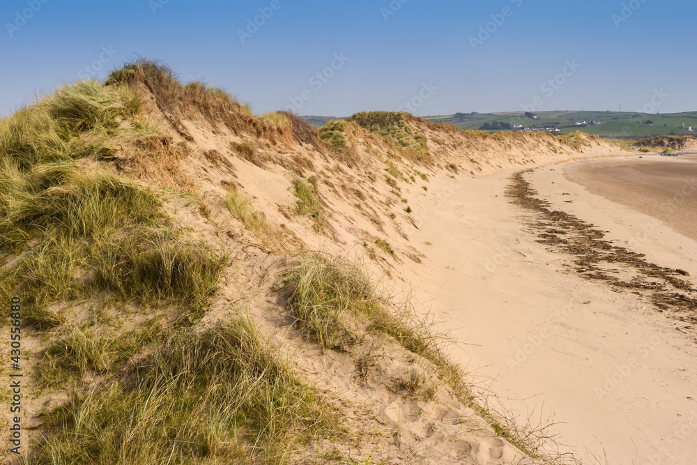 Sand dunes leading to the sea in a beach holiday setting Sand dunes leading to the sea in a beach holiday setting