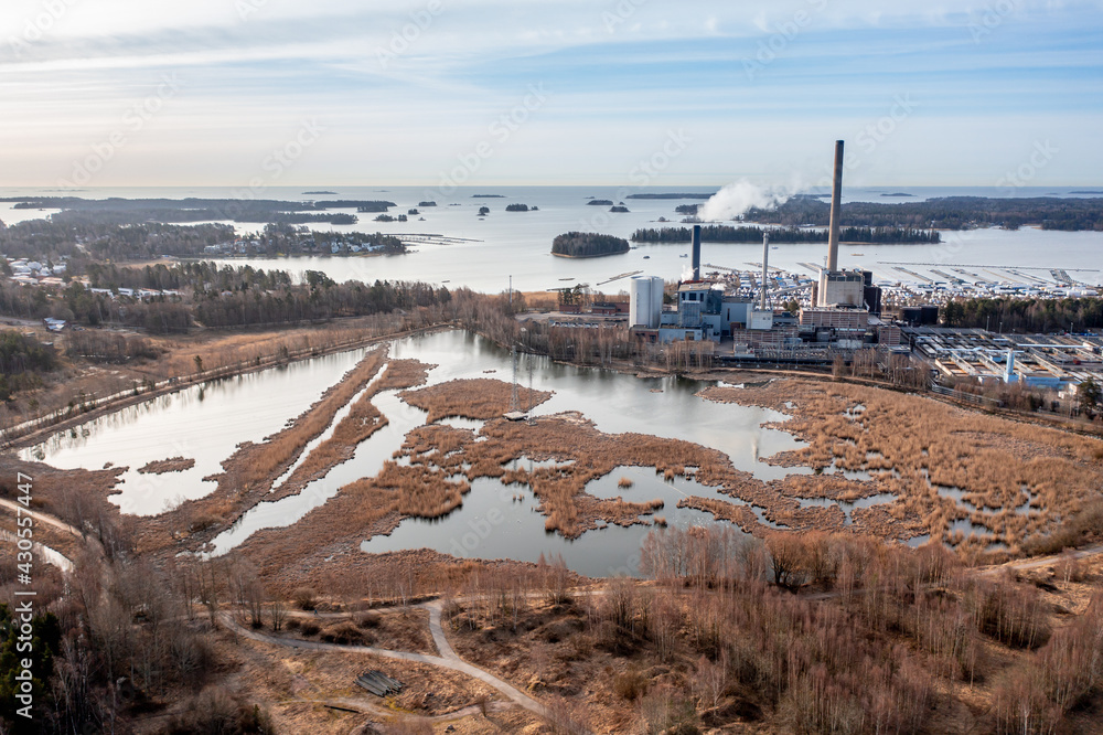 Aerial view of the pond Suomenoja, one of the best places for birdwatching in Espoo, Finland. The combined heat and power plant on the Baltic seashore.