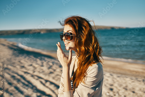 woman travels on the beach in sunglasses in the mountains in nature