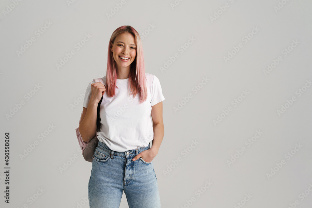 Smiling young woman standing with backpack Smiling young woman standing with backpack