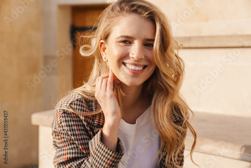Close up of a smiling young blonde casual woman