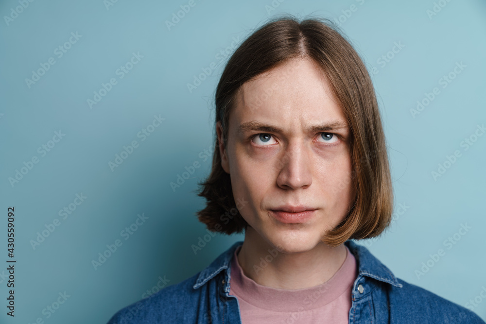 Young european man frowning and looking upward Young european man frowning and looking upward