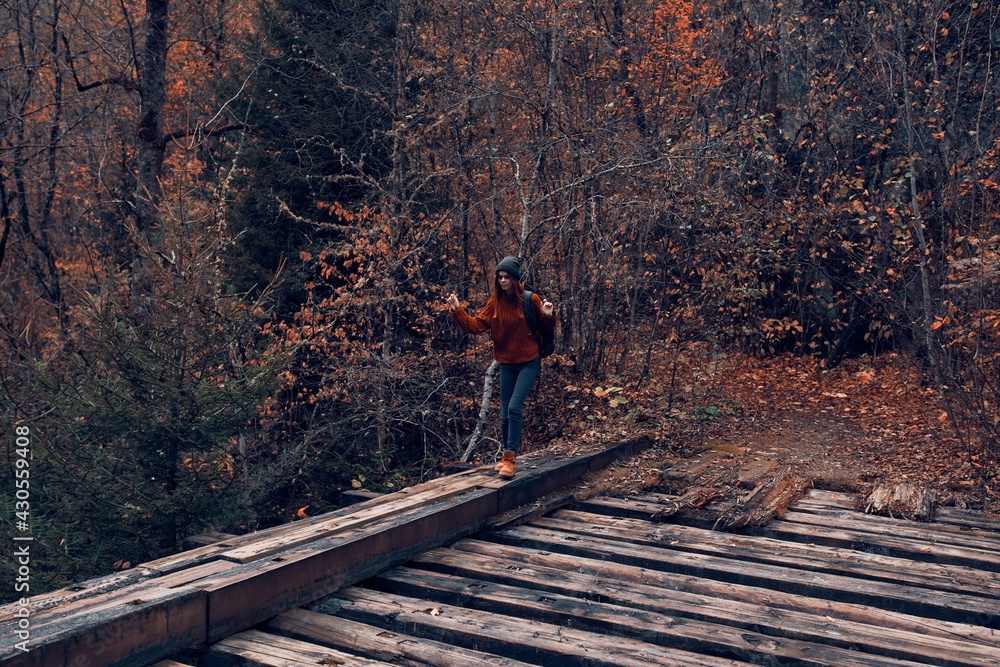 woman tourist crosses the bridge over the river travel in autumn woman tourist crosses the bridge over the river travel in autumn