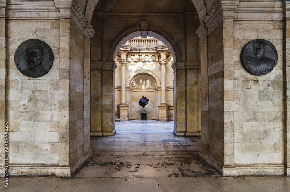 Naklejka premium Heraklion, Crete Island, Greece. Venetian Loggia, interior view. Looking through the arches from the courtyard to the atrium. Bronze shields figuring two cretan archaeologists