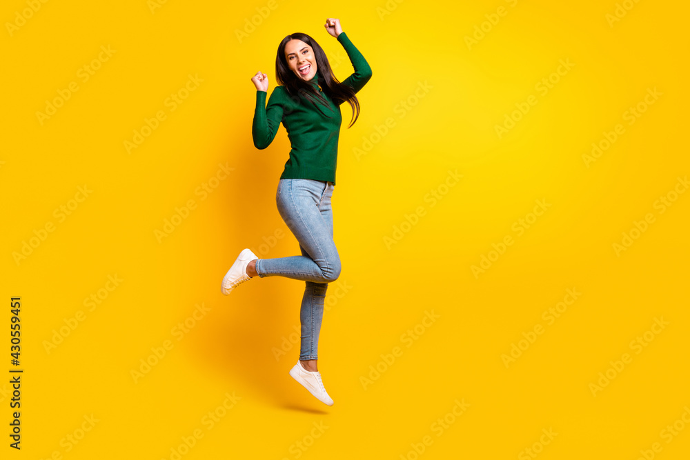 Full length photo of cheerful victorious woman jump up raise fists winner isolated on yellow color background