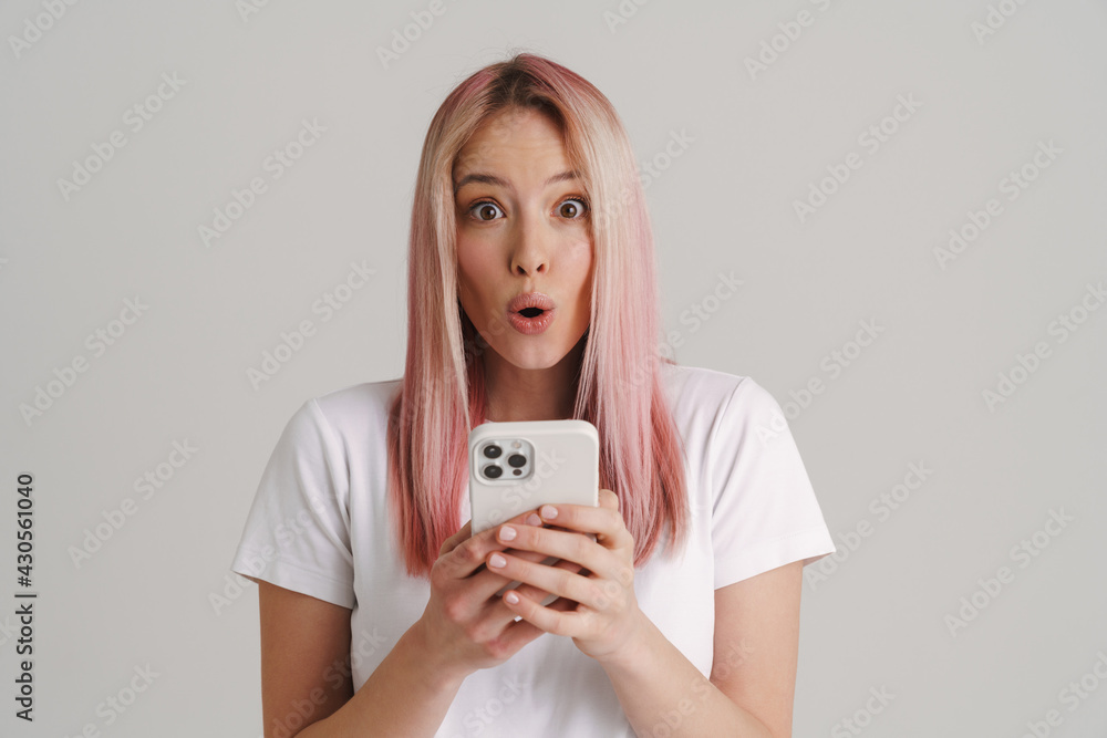 Young shocked woman exclaiming while using mobile phone Young shocked woman exclaiming while using mobile phone
