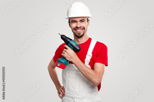 Delighted contractor with electric screwdriver