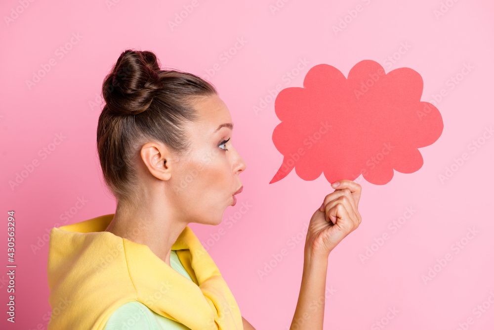 Photo of impressed cute young lady dressed green t-shirt holding thought cloud empty space isolated pink color background