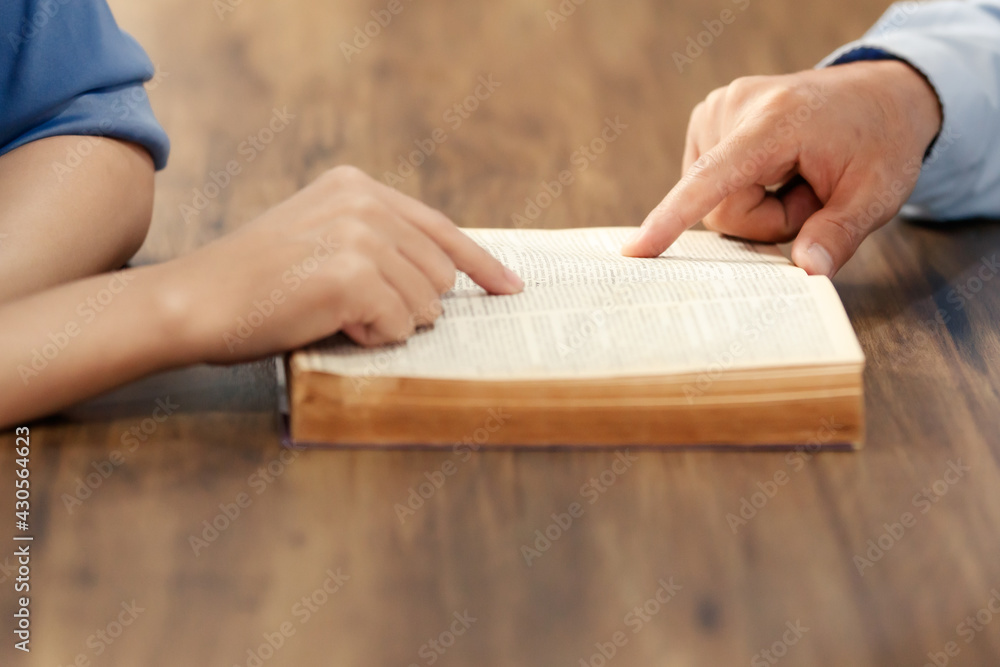 Close up hand. Asain Man is also reading the Bible. According to beliefs and beliefs in Christianity. Concept reading bible believe.. Close up hand. Asain Man is also reading the Bible. According to beliefs and beliefs in Christianity. Concept reading bible believe..