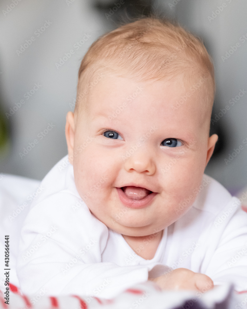Sly looking newborn smiling baby portrait Sly looking newborn smiling baby portrait