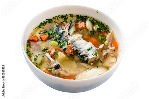 Hot tasty healthy soup with fish and vegetables served on a round plate