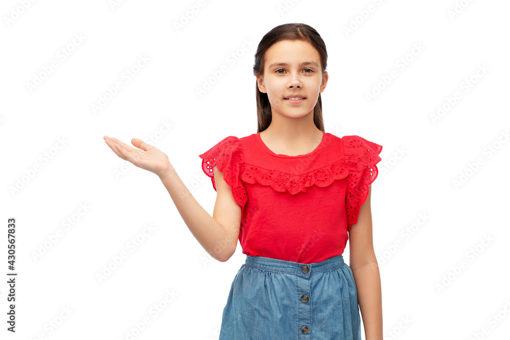 childhood, fashion and people concept - happy smiling girl holding something imaginary on her hand over white background childhood, fashion and people concept - happy smiling girl holding something imaginary on her hand over white background