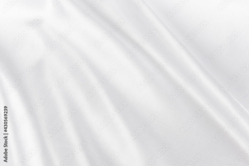 Abstract white silk fabric texture background. Cloth soft wave. Creases of satin