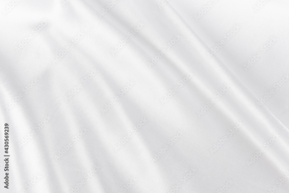 Abstract white silk fabric texture background. Cloth soft wave. Creases of satin Abstract white silk fabric texture background. Cloth soft wave. Creases of satin