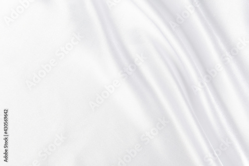 Abstract white silk fabric texture background. Cloth soft wave. Creases of satin