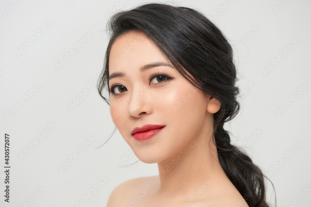 Closeup young romantic lady in wedding festive dress standing indoors on light background, pretty woman posing Closeup young romantic lady in wedding festive dress standing indoors on light background, pretty woman posing