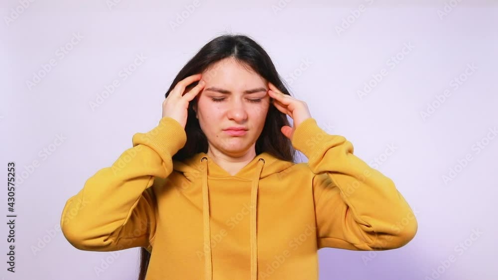 A woman suffers from headaches, migraines, does a head and temple massage. Increased intracranial pressure. Medicine and headache treatment A woman suffers from headaches, migraines, does a head and temple massage. Increased intracranial pressure. Medicine and headache treatment