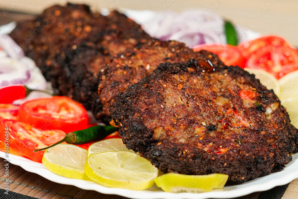 chapli kabab desi Pakistani food display in a plate Stock Photo | Adobe ...