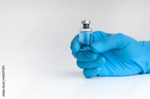 Doctors wear masks and glasses, scientists hold syringes and vaccines. Vaccination and laboratory experiments, COVID-19 virus protection concept, vaccine invention and production concept.