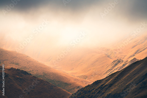 Autumn mountains in misty morning. Gil-Su valley in North Caucasus, Russia. Beautiful autumn landscape