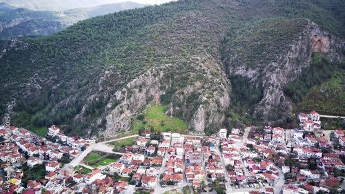 Drone view on world famous unesco Tomb of Amyntas in Fethiye. Rock cutted lucian empire tombs inside the green mountain
 photo