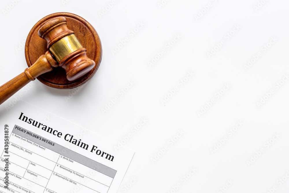 Insurance claim form with judge gavel . Top view Insurance claim form with judge gavel . Top view