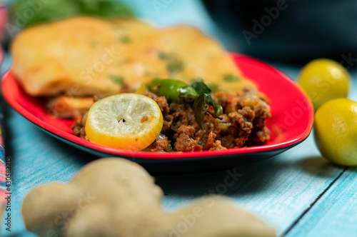 Qeema karahi with vegetable roghni naan Pakistan and India food photo