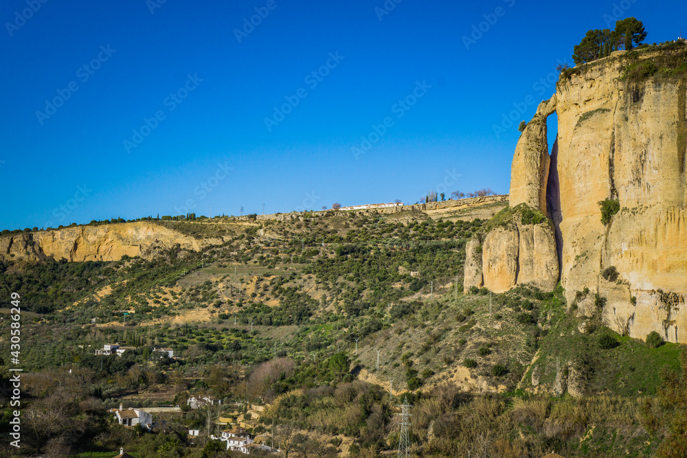 View on the cliffs from the foot of the Ronda bridge in Andalusia, Spain