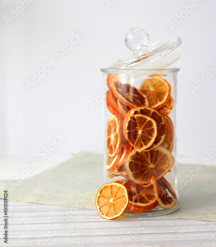 dried fruit in a jar and on the table. vegetarianism and healthy eating. energy for all time from healthy food. beautiful fruits in jars. weight loss. orange white glass. High quality photo