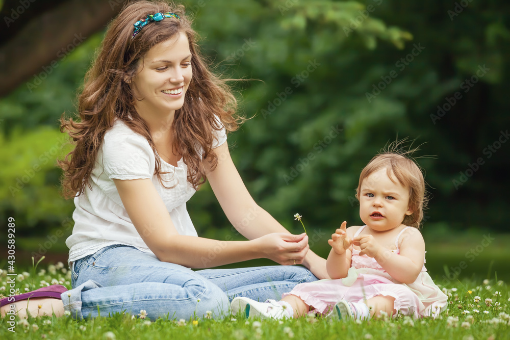 Mother and little daughter playing in the park Mother and little daughter playing in the park