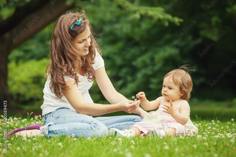 Mother and little daughter playing in the park