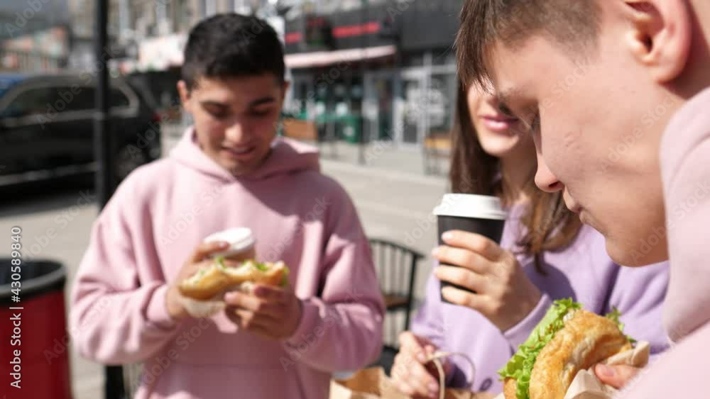 Group of friends with drinks and food, enjoy socializing on the street in the park. Party with friends. Coffee to go Group of friends with drinks and food, enjoy socializing on the street in the park. Party with friends. Coffee to go