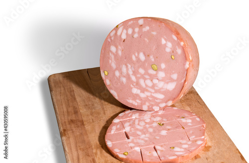 Mortadella Bologna with pistachios on wooden cutting board isolated on white