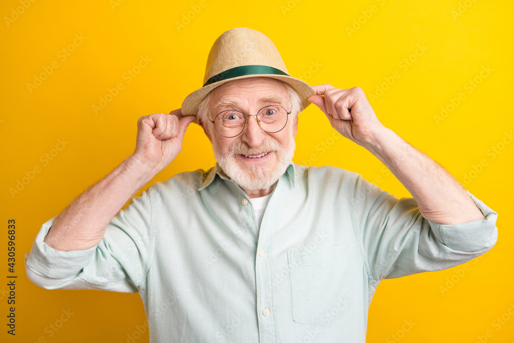 Photo of confident cute age gentleman wear green shirt spectacles arms headwear isolated yellow color background Photo of confident cute age gentleman wear green shirt spectacles arms headwear isolated yellow color background