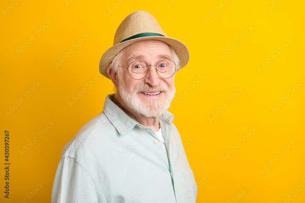 Photo of pretty charming mature man dressed green shirt cap smiling empty space isolated yellow color background Photo of pretty charming mature man dressed green shirt cap smiling empty space isolated yellow color background