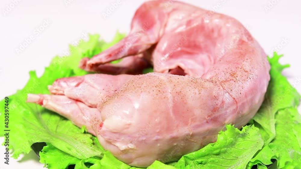 The cook sprinkles rabbit meat with black ground pepper. Seasonings for meat, cooking low-fat meat The cook sprinkles rabbit meat with black ground pepper. Seasonings for meat, cooking low-fat meat