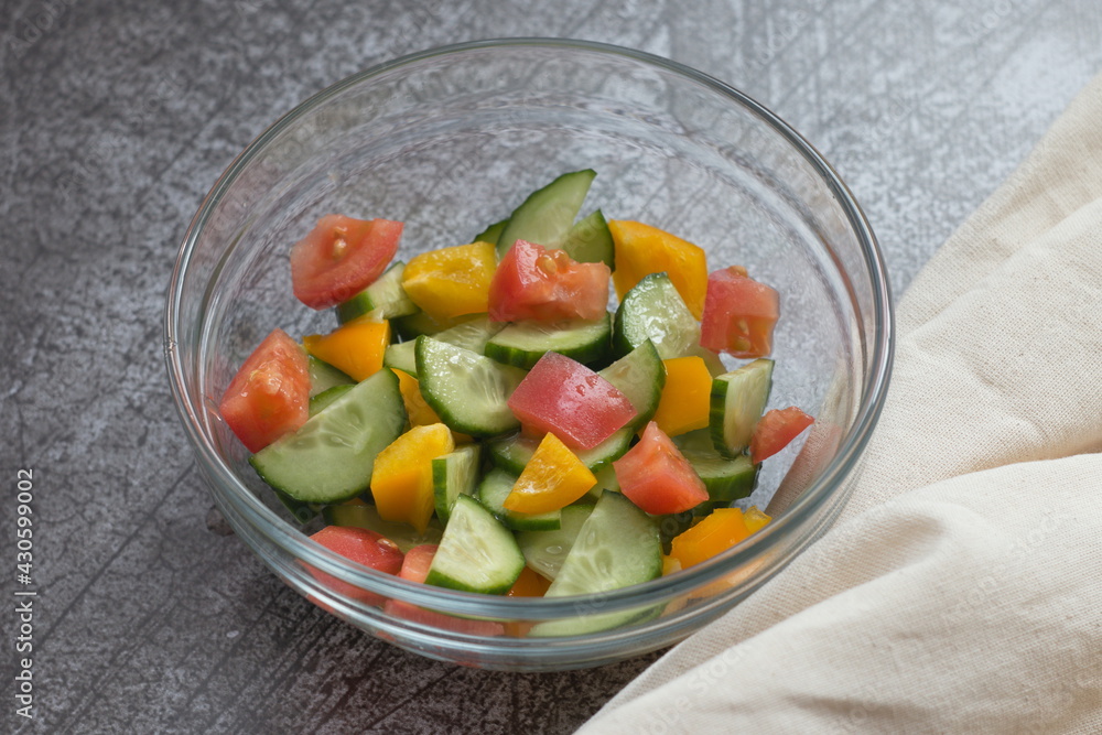 Bright vegetable salad in a transparent bowl, a dish for proper nutrition Bright vegetable salad in a transparent bowl, a dish for proper nutrition