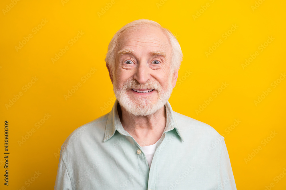 Photo of handsome cute age gentleman wear green shirt smiling isolated yellow color background Photo of handsome cute age gentleman wear green shirt smiling isolated yellow color background