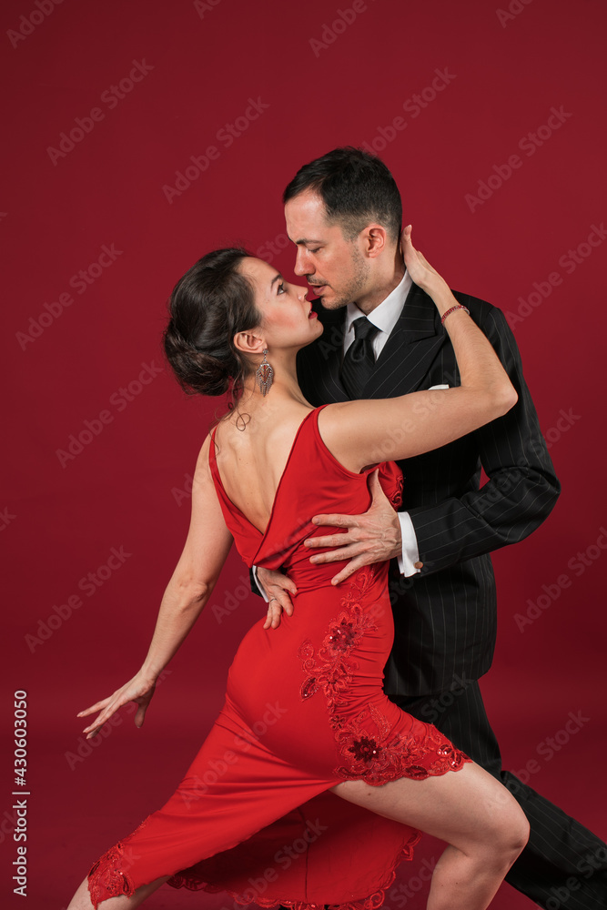 Couple of professional tango dancers in elegant suit and dress pose in ...